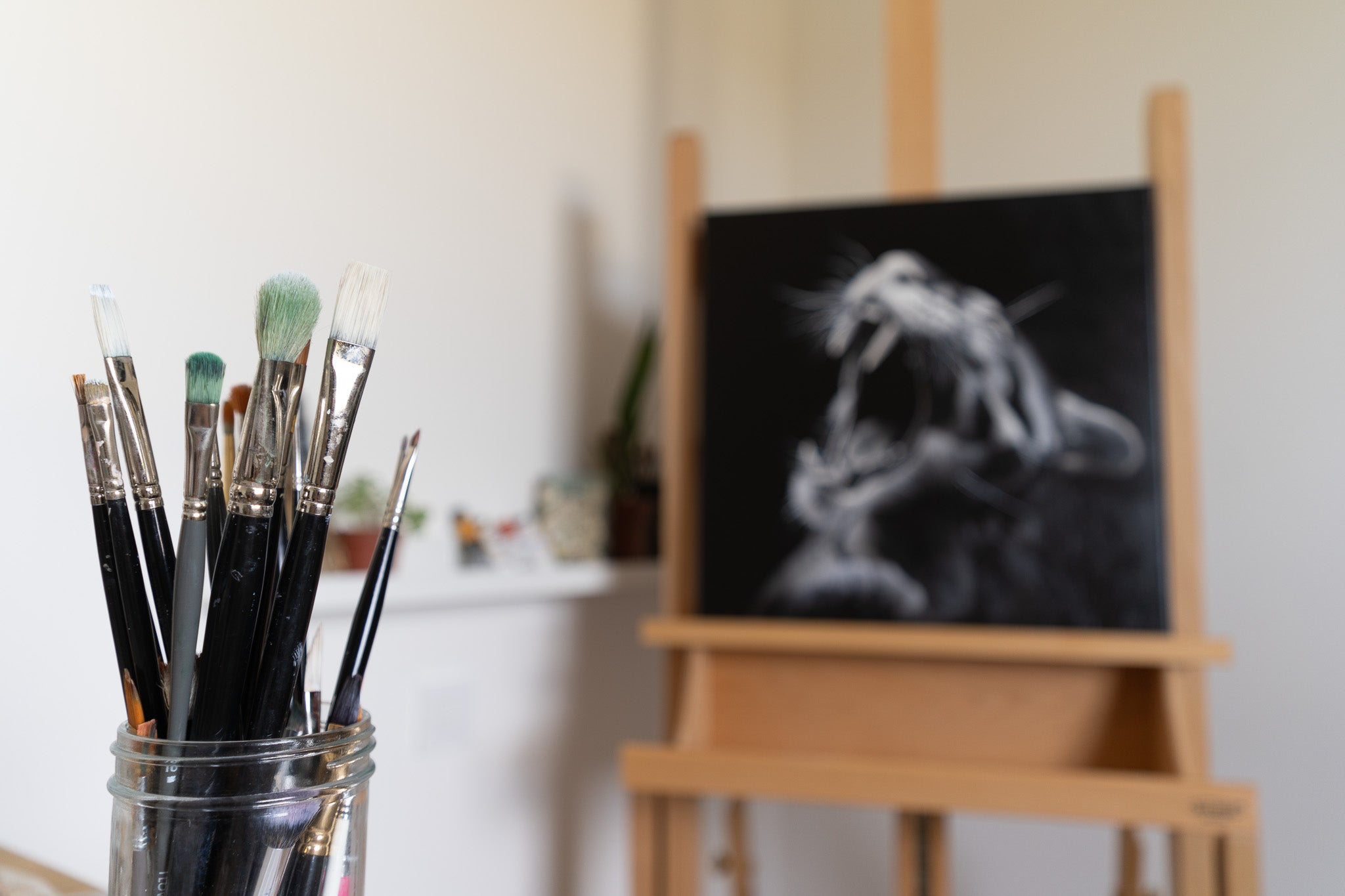 a close up picture of my brushes and blurry in the background : a leopard painting